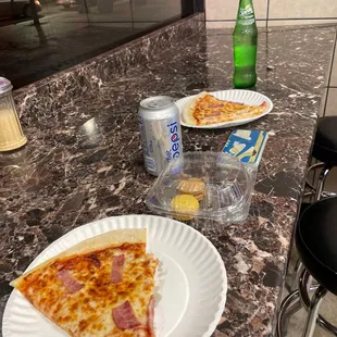 a slice of pizza on a paper plate