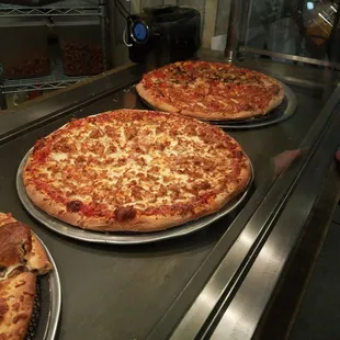 three pizzas on a counter