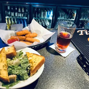 Mozzarella sticks, Caesar salad with garlic toast, and an amber ale.