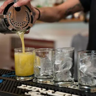 a bartender pouring a drink