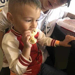 a young boy eating a donut