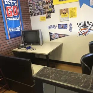 a desk with a computer and a television