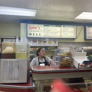 a woman behind the counter