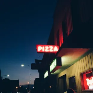 a neon sign for a pizza restaurant