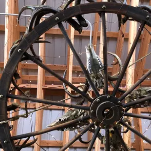 Wooden wheel chandelier overhead. You can see the teeth in these animal skulls!