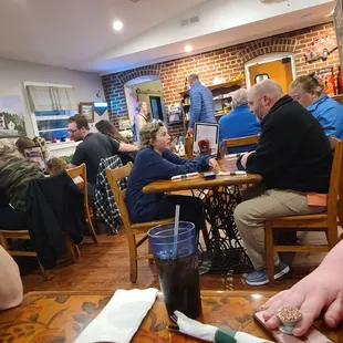 people eating and drinking at a restaurant