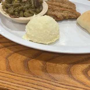 Dry mashed potatoes and unidentifiable chicken fried steak