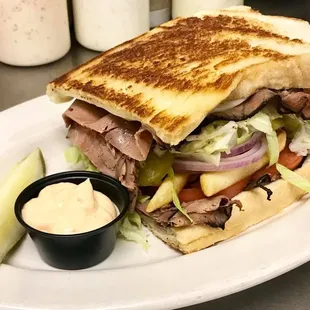 a roast beef sandwich with pickles