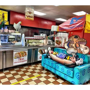 a dog sitting on a couch in a diner