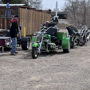 a green motorcycle with a side car