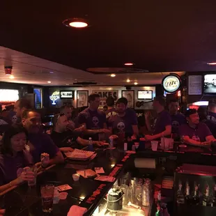 a large group of people sitting at a bar
