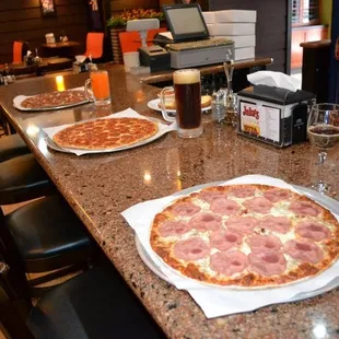 two pizzas on the counter