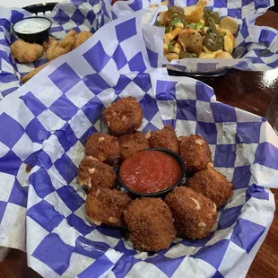 Fried pickles (left), chorizo cheese fries (right), mozz tots (front)