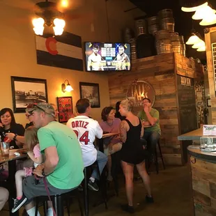 a group of people sitting at a bar