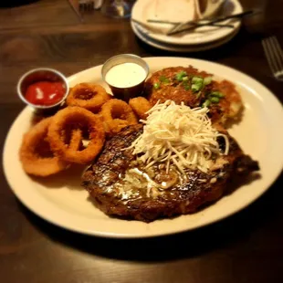 18 oz Boneless ribeye w/ onion rings and potato pancakes