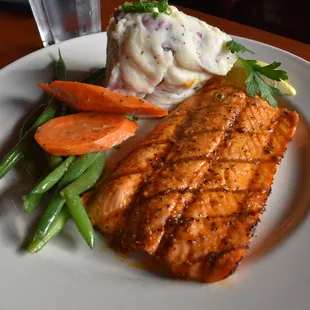 a plate of salmon, green beans, and mashed potatoes