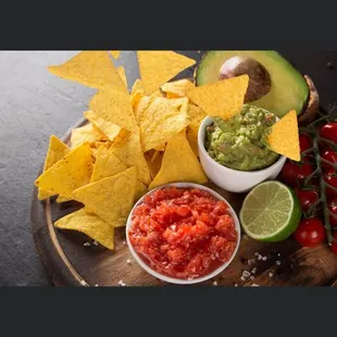 guacamole, tortillas, tomatoes, and limes