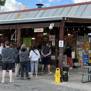 a group of people standing outside a store