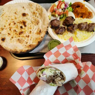 Naan, lamb kabobs on rice with green salad and spiced pumpkin