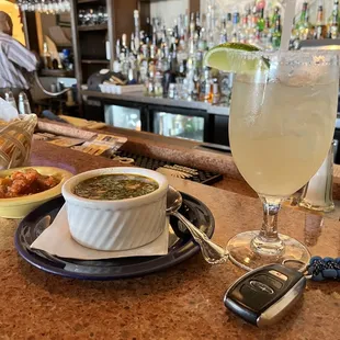 a drink and a cell phone on a bar