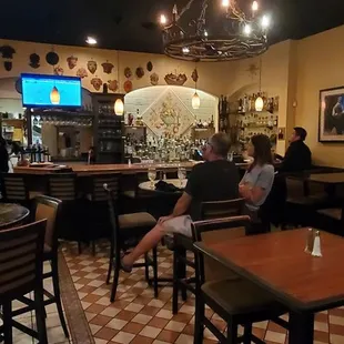 Full bar and plenty of seats, with a large television.