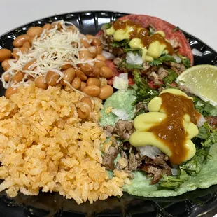 Asada tacos with side of rice and beans.