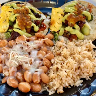Pastor tacos with cheese and pineapple and side of rice and beans.