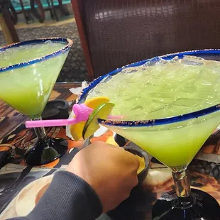 a person holding a margarita