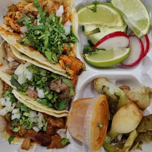 From top to bottom: pollo loco, carnitas, and al pastor tacos