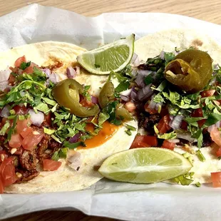 Barbacoa Taco on left; Steak Taco on right