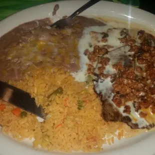3 Amigos Steak, pollo and chorizo in a nacho cheese sauce with rice beans and warm tortillas