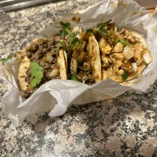 My 2 dry af left over tacos and my partners one leftover taco wrapped in  paper bc we were going to be charged $6 for a box. BYE.