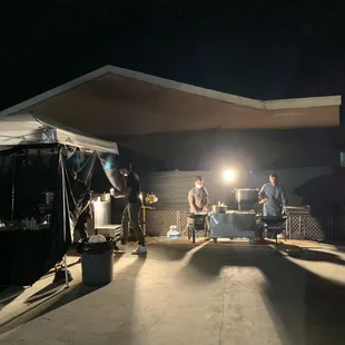 a group of people sitting under a tent