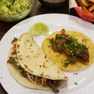 Barbacoa, and American beef taco, with a side of guacamole.