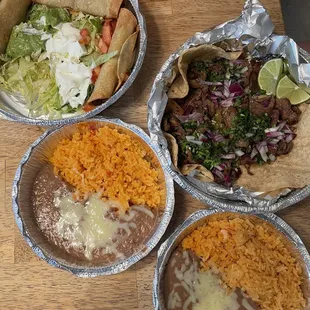 Carne asada tacos, rice and beans, beef flautas
