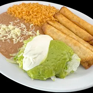 4 flautas plate. Refried beans and Mexican rice, served with fresh crispy lettuce , guacamole, sour cream