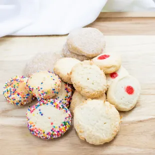 a variety of cookies on a cutting board
