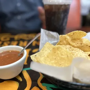 a bowl of salsa and chips