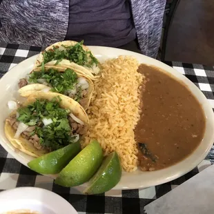 Street tacos (chicken and beef) with rice and refried beans.