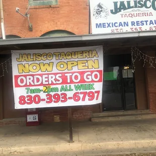 a sign in front of a restaurant