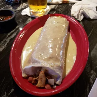 a burrito on a red plate