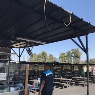 a man standing under a awning