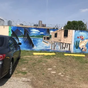 Parking area in front. LOVE the painting. Reminds me of back home.