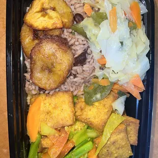 Curry tofu serve with rice and peas with cabbage and plantain