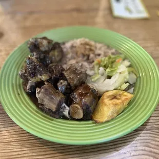 Oxtail, plantain, salad, beans and rice