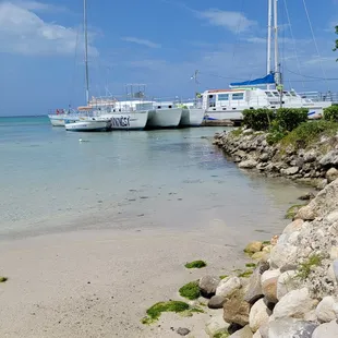 two boats docked on a beach