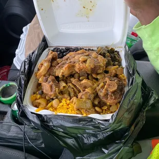 Oxtail with curry rice,black beans, greens and coco bread