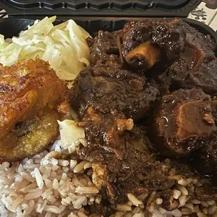 Oxtail Fried Plantains (6) Steamed cabbage Rice and Peas