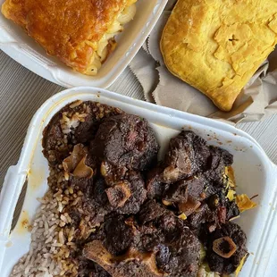 Oxtail, Rice and Peas, Steamed cabbage, Macaroni and Cheese, beef patty
