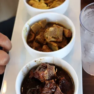 Sampler: Curry Goat, Curry Chicken, Oxtails and also Jerk Chicken.